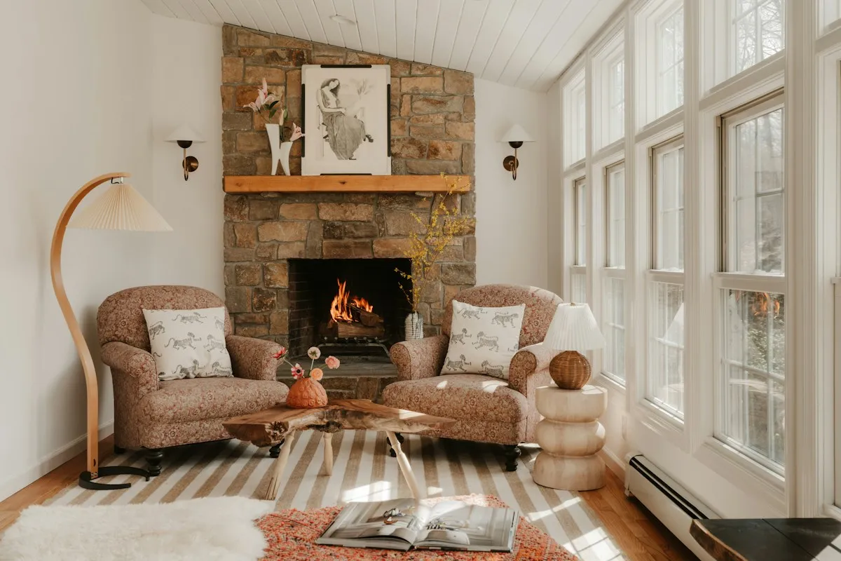 Stone fireplace with a fire in a bright living room
